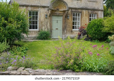 Exterior View And Garden Of A Beautiful Old Cottage House On A Street In An English Town