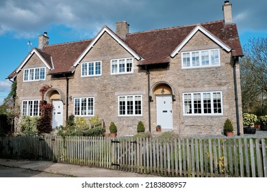 Exterior View And Garden Of Beautiful Old Cottage Houses On A Street In An English Town