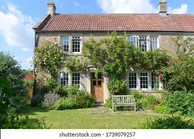 Exterior View and Garden Lawn of a Beautiful Old Rural English Cottage House - Shutterstock ID 1739079257