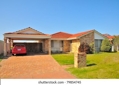 Exterior View Of Generic House With Car In Garage.