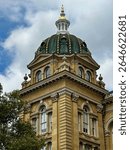 Exterior view of the Iowa State Capitol in Des Moines, featuring its iconic golden dome and historic architecture. Some images show the full building, others highlight detailed sections.