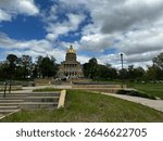 Exterior view of the Iowa State Capitol in Des Moines, featuring its iconic golden dome and historic architecture. Some images show the full building, others highlight detailed sections.