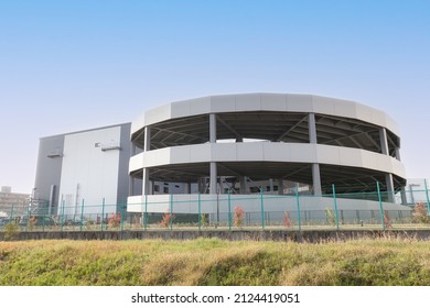 Exterior View Of Large Distribution Warehouse With Spiral Ramps For Vehicle Entry And Exit In Japan