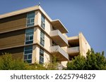 Exterior view of modern apartment building offering units in Silicon Valley, San Francisco Bay Area, California. New construction apartment or condo complex