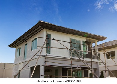 Exterior view of new house under construction and painting.