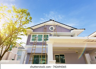 Exterior View Of New House Under Construction And Painting