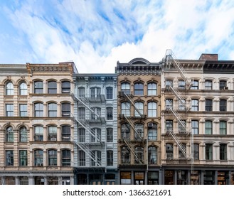 Exterior view of old apartment buildings in the SoHo neighborhood of Manhattan in New York City with empty blue sky background overhead