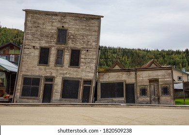 Exterior View Of An Old Broken And Slanted House In A Small Touristic Town, Dawson City, During A Sunny Summer Day. Yukon, Canada.