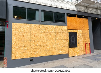 Exterior View Of Permanently Closed Business, Store, Restaurant Boarded Up With Plywood Sheets To Prevent Unauthorized Access By Squatters, Looters Or Vandals To Unused, Vacant, Or Abandoned Property.