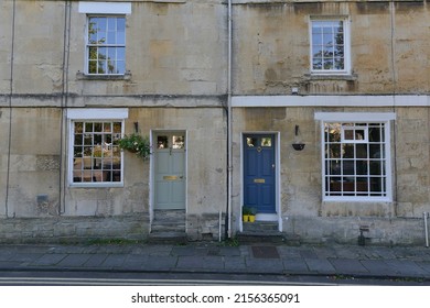 Exterior view of two old town houses on a residential street in an English city