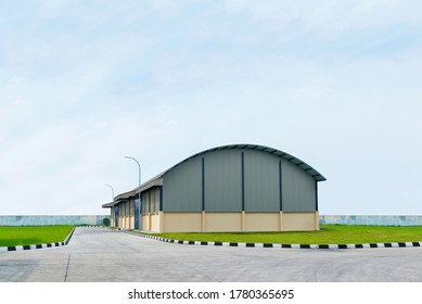 Exterior View Of A Warehouse Building With A Blue Sky Background