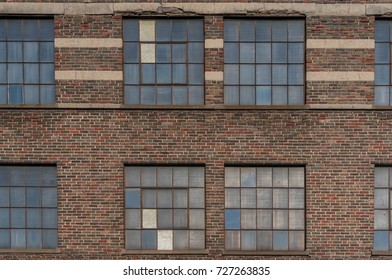 Exterior Of A Vintage Brick Warehouse With Old Windows For Use A Background Texture