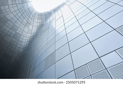 The exterior wall of a contemporary building is clad in metal panels, creating a futuristic and abstract architectural design - Powered by Shutterstock