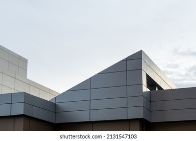 The exterior wall of a contemporary commercial style building with aluminum metal composite panels and glass windows. The futuristic building has engineered diagonal cladding steel frame panels. - Shutterstock ID 2131547103