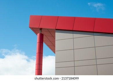 The exterior wall of a contemporary commercial style building with aluminum metal composite panels and glass windows. The futuristic building has engineered diagonal cladding steel frame panels. - Shutterstock ID 2137184099