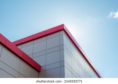 The exterior wall of a contemporary commercial style building with aluminum metal composite panels and glass windows. The futuristic building has engineered diagonal cladding steel frame panels. - Shutterstock ID 2143333771
