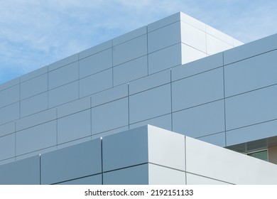 The exterior wall of a contemporary commercial style building with aluminum metal composite panels and glass windows. The futuristic building has engineered diagonal cladding steel frame panels. - Shutterstock ID 2192151133