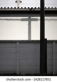 Exterior Wall And Shadow Of Telephone Pole          