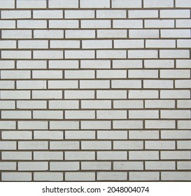 Exterior Wall In White Brick In Classic Subway Tile Pattern With Dark Grey Mortar.  Background Or Back Drop Image.