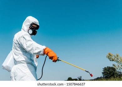 exterminator in protective uniform holding toxic spray outside  - Powered by Shutterstock