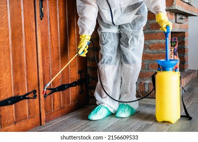 Exterminator In Work Wear Outdoors Spraying Pesticide With Sprayer