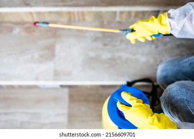 Exterminator In Work Wear Outdoors Spraying Pesticide With Sprayer