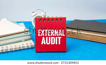 External Audit Concept Red Notepad Text EXTERNAL AUDIT Blue Desk Office Supplies Business Financial Examination Compliance Review. 