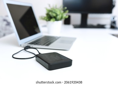 External backup disk hard drive connected to laptop - Shutterstock ID 2061920438