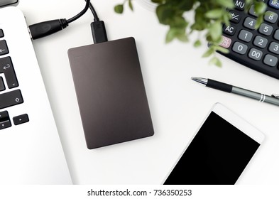External backup disk hard drive connected to laptop. hard drive backup disk external computer data usb concept