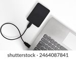 External backup hard disk drive connected to laptop on white background. external hard disk connect by USB 3.0 port to laptop