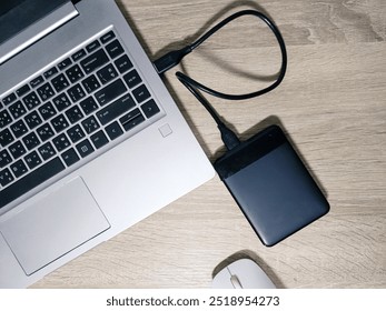 External backup hard disk drive connected to laptop on white background. external hard disk connect by USB 3.0 port to laptop