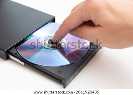 External DVD drive reader, man putting disc. Data security, digital data storage