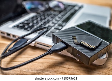 External Hard Disk And Memory Cards On Laptop Keyboard.High Dynamic Range Tone