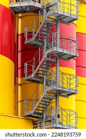 An external metal staircase on the silos in a petrochemical factory plant - Shutterstock ID 2248193759