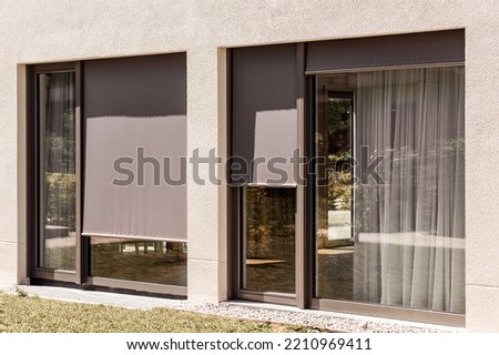External Roller Blinds Outdoor on Panoramic Windows. Fabric Sun Protection Shutters Outside.