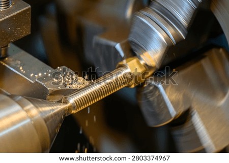 The external threading and  turning process on brass shaft components using a lathe machine.