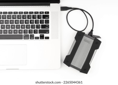 External USB hard drive isolated on white background. Waterproof protected external hard drive. Hard disk for connecting to a laptop, transferring data between a computer and a hard disk.