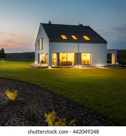 External View Of Stylish And Modern House With Outdoor Lights At Night