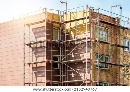 External wall insulation during spring season. Solid wall insulation. Energy efficiency house wall renovation for energy saving.