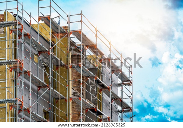 External wall insulation.\
Energy efficiency house wall renovation for energy saving. Exterior\
house wall heat insulation with mineral wool, building under\
construction.