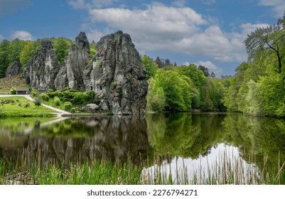 Externsteine Germany is a Sandstone Rockformation whose withered shapes have talked to the Mystic sides of Man ever since the Stone Ages.reflection in the water