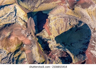 Extinct Volcano Crater And Lava Fields Of Berserkjahraun Region, Snaefellsnes Peninsula, Iceland. A Dirt Road Can Be Seen Winding Through Region And A Car Shows Perspective. Overhead View Drone Shot.