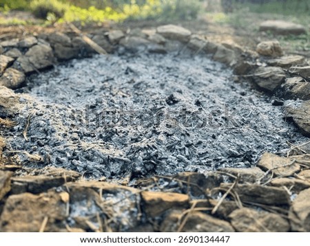 Extinguished Campfire with Ashes and Stones – Soft Morning or Evening Light