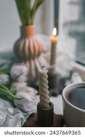 Extinguished candle in a modern interior.