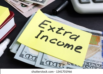 Extra Income Written On A Piece Of Paper And Cash.