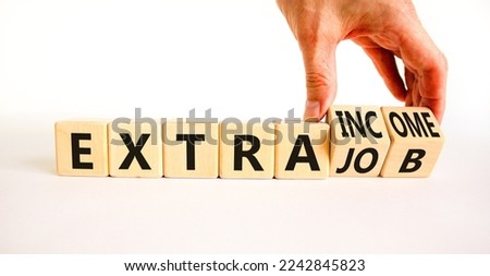 Extra job and income symbol. Concept words Extra job Extra income on wooden cubes. Businessman hand. Beautiful white table white background. Business extra job and income concept. Copy space.