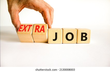Extra job symbol. Businessman turns wooden cubes and changes concept words Job to Extra job. Beautiful white table white background, copy space. Business extra job concept. - Shutterstock ID 2130008003