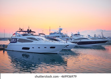 Extra Large Luxury yachts rest in the port at sunset