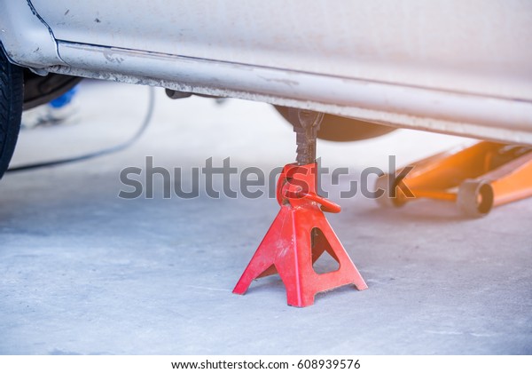 Extra safety measures are taken by\
using a hydraulic jack and jack stand to lift up a\
vehicle.