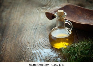 Extra virgin healthy Olive oil with fresh olives on rustic wooden background